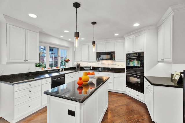 kitchen featuring white cabinetry, a center island, pendant lighting, and black appliances