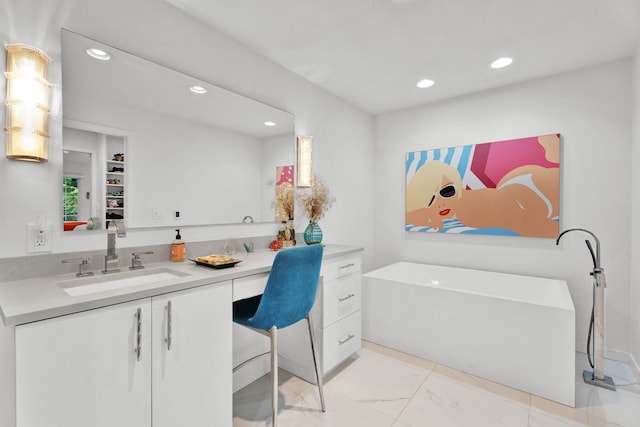 bathroom with vanity, a bathtub, and built in features