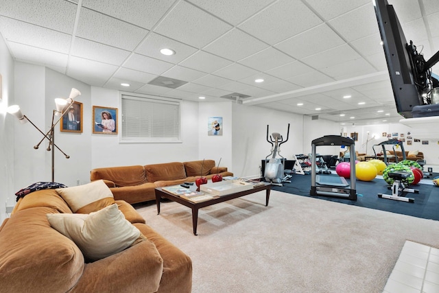 carpeted living room with a paneled ceiling