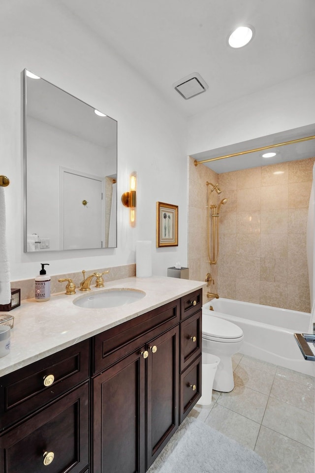 full bathroom with tile patterned floors, vanity, toilet, and tiled shower / bath combo