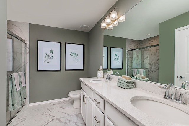 full bath featuring a marble finish shower, marble finish floor, and a sink