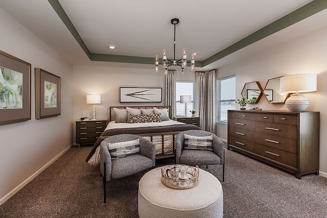 carpeted bedroom with baseboards, an inviting chandelier, and a raised ceiling