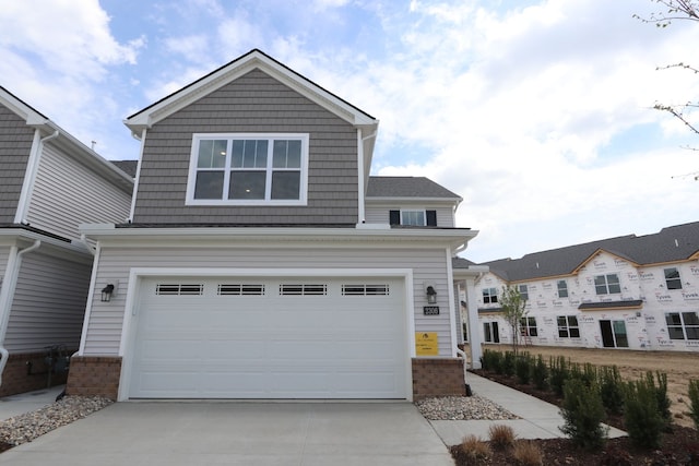 craftsman-style house with concrete driveway, brick siding, and a garage