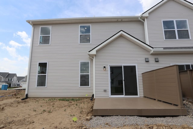 back of property featuring a wooden deck