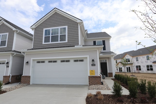 craftsman-style house with concrete driveway, brick siding, and a garage