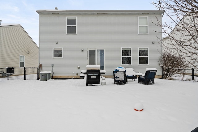 snow covered property featuring central AC unit