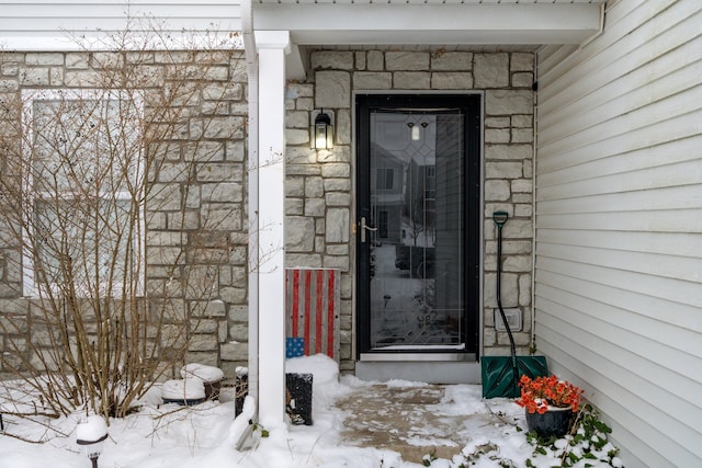 view of snow covered property entrance