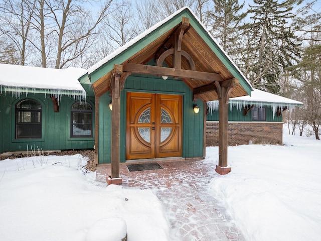 view of snow covered property entrance