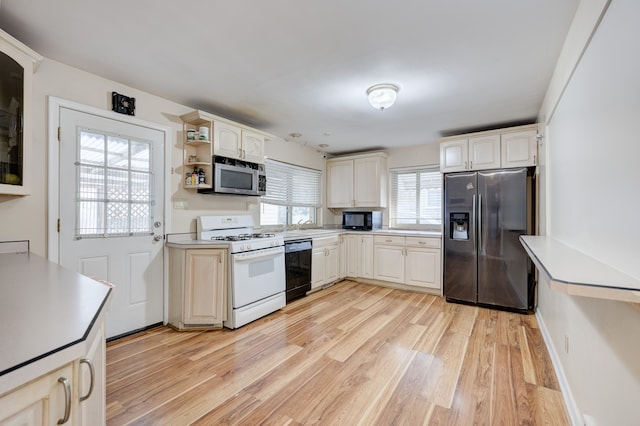 kitchen featuring sink, light hardwood / wood-style flooring, and stainless steel appliances