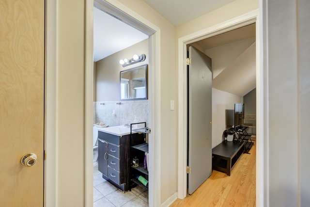 bathroom featuring decorative backsplash, vanity, and wood-type flooring