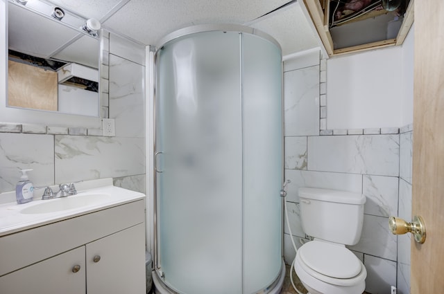 bathroom featuring vanity, toilet, an enclosed shower, and tile walls