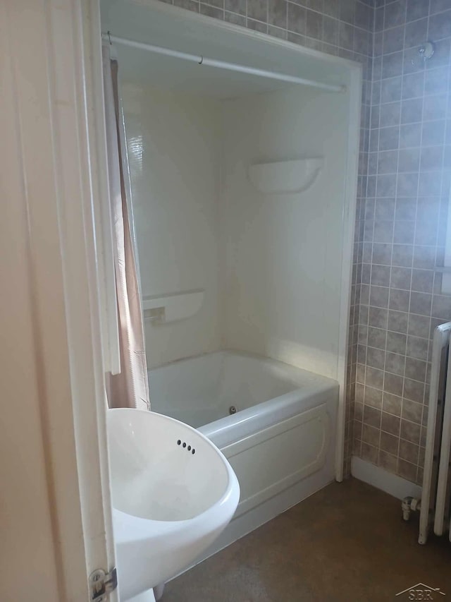 bathroom with radiator and shower / bath combo with shower curtain