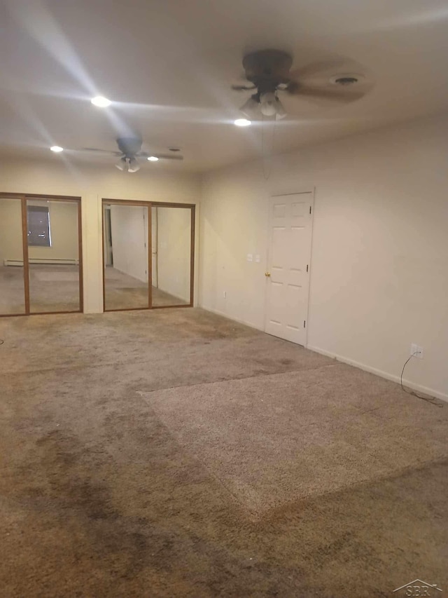 spare room featuring carpet, electric panel, and ceiling fan