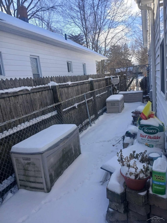 snowy yard with ac unit