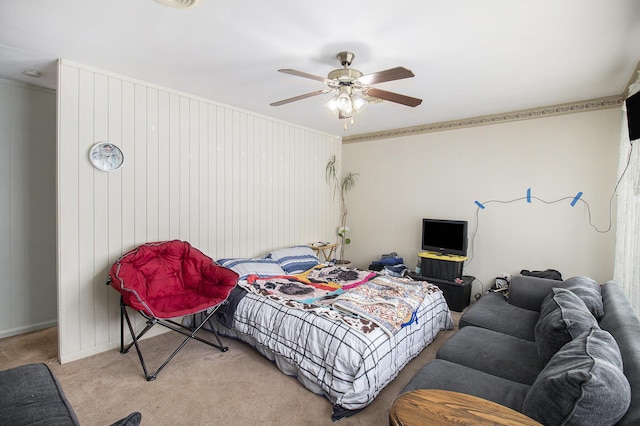 bedroom featuring ceiling fan, ornamental molding, and carpet floors