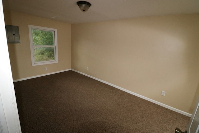 27116 Seyburn Ave, Warren, MI 48092 - unfurnished room featuring electric panel, baseboards, and dark colored carpet