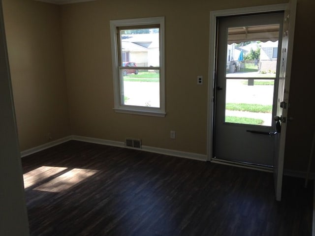 27116 Seyburn Ave, Warren, MI 48092 - doorway featuring dark wood-style flooring, baseboards, and healthy amount of natural light