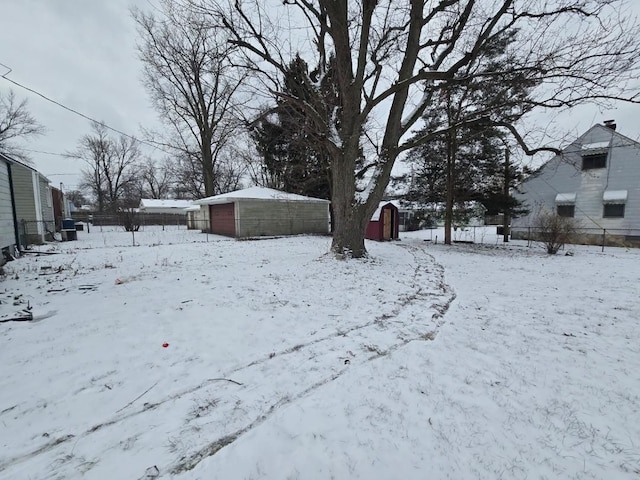 snowy yard with a storage shed