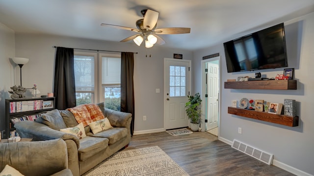 living room with wood-type flooring and ceiling fan