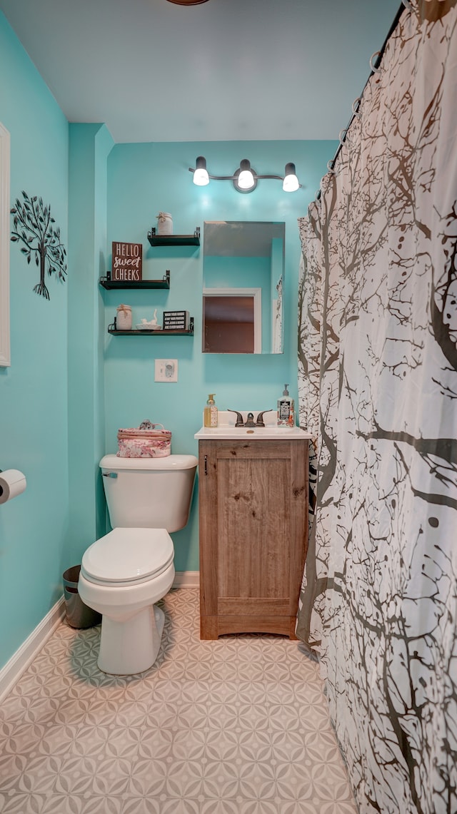 bathroom featuring vanity, tile patterned floors, and toilet