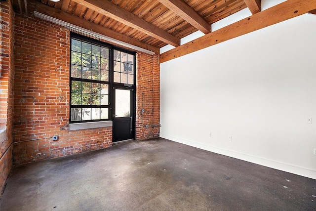 unfurnished room featuring brick wall, beam ceiling, and a high ceiling