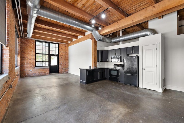 kitchen with brick wall, sink, a high ceiling, and black appliances