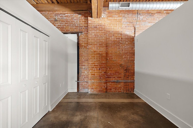 corridor featuring brick wall