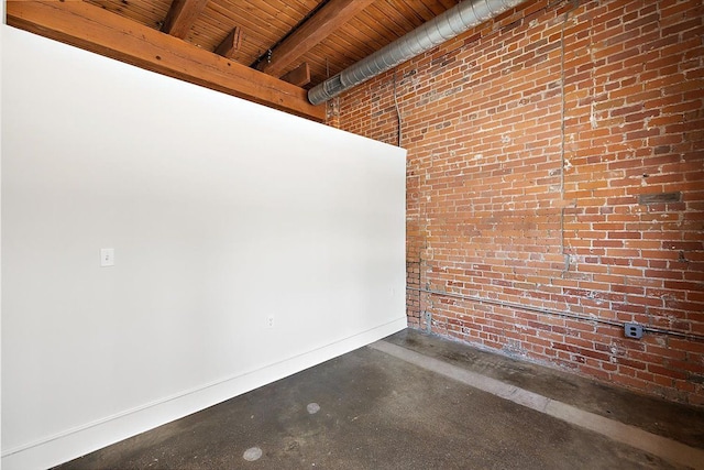 spare room featuring beamed ceiling, brick wall, and wood ceiling