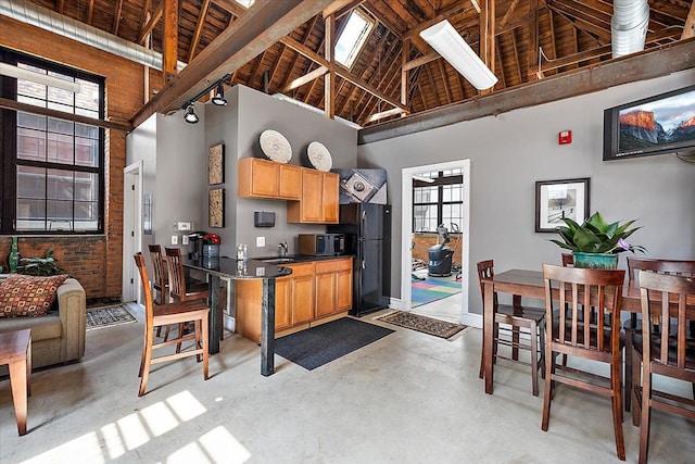 kitchen featuring wooden ceiling, sink, high vaulted ceiling, and black appliances