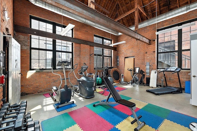 interior space featuring brick wall and a towering ceiling