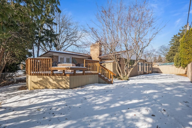 snow covered property with a wooden deck