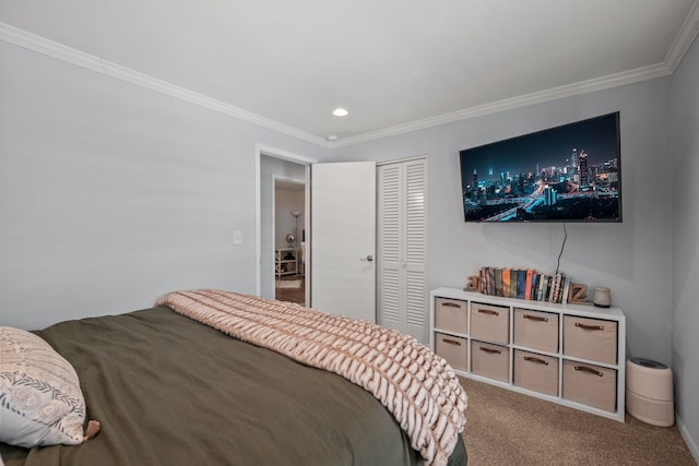 carpeted bedroom with ornamental molding and a closet