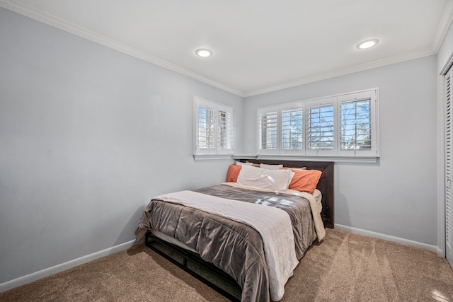 bedroom featuring ornamental molding, carpet flooring, and a closet