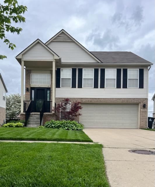 view of front of property with a garage and a front lawn