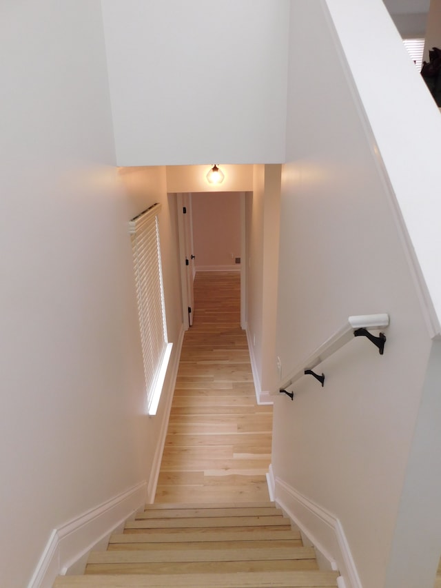 stairs featuring hardwood / wood-style flooring