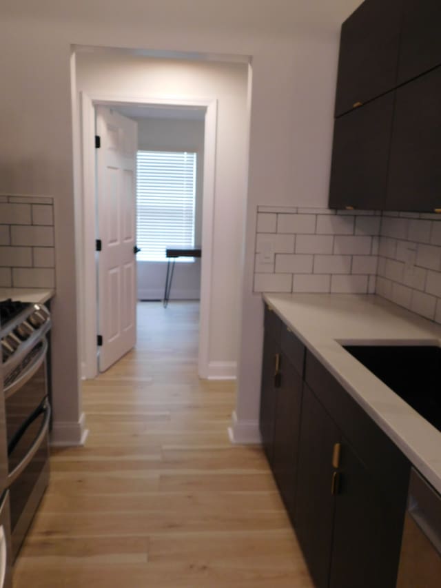 kitchen featuring appliances with stainless steel finishes, sink, and light hardwood / wood-style flooring