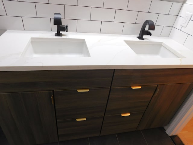 bathroom featuring vanity and decorative backsplash