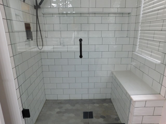 bathroom with tiled shower