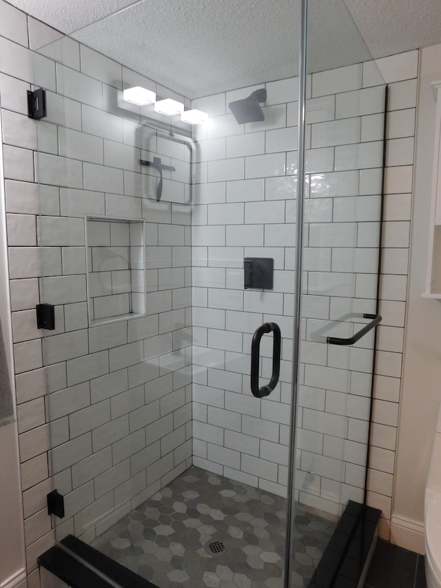 bathroom with a shower with door