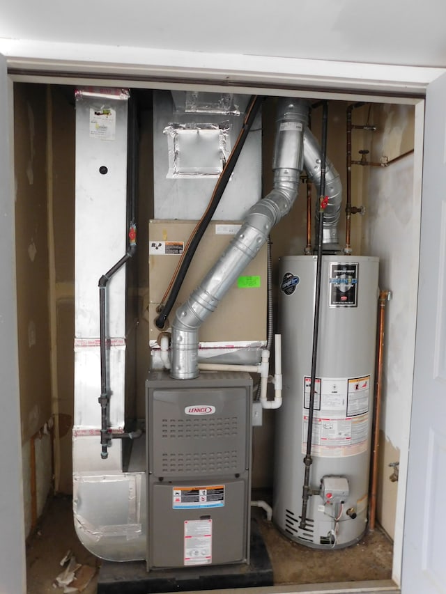 utility room featuring heating unit and gas water heater