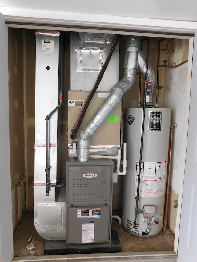 utility room with heating unit and water heater