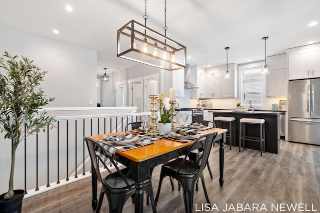 dining area with sink and hardwood / wood-style floors