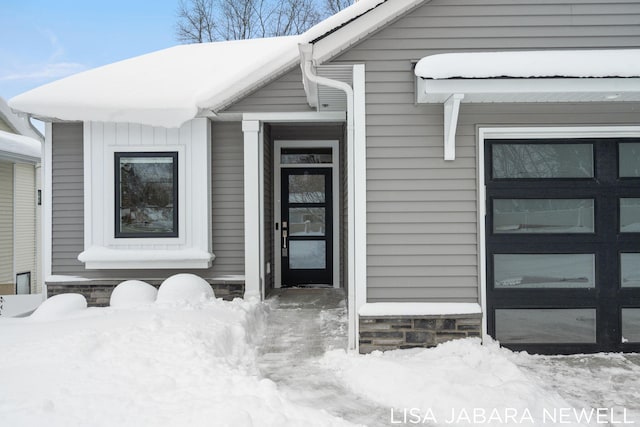 view of snow covered property entrance