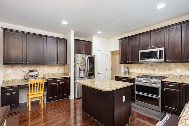 kitchen featuring light stone countertops, dark brown cabinets, stainless steel appliances, and dark hardwood / wood-style floors