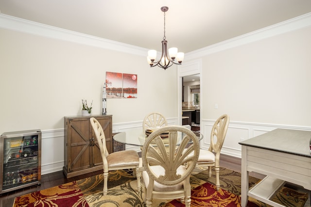 dining room with a notable chandelier, ornamental molding, wine cooler, and dark hardwood / wood-style flooring