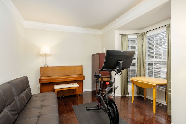 workout area with dark wood-type flooring and crown molding