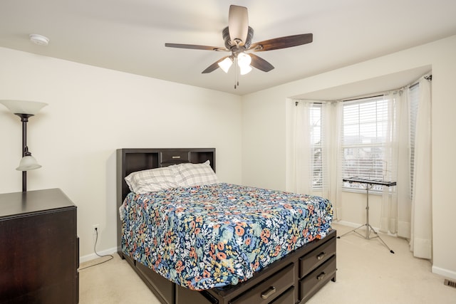 bedroom with ceiling fan and light carpet