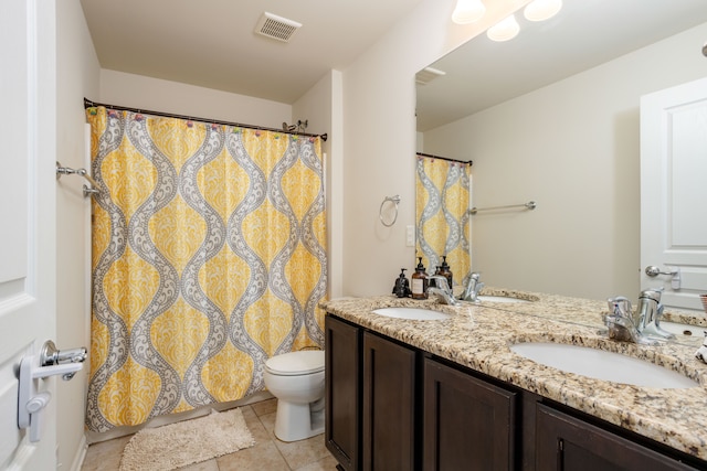 bathroom featuring vanity, toilet, and tile patterned flooring