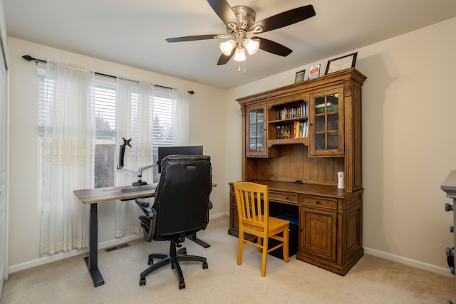 carpeted office space with ceiling fan