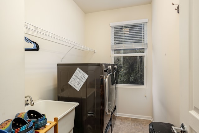 laundry area featuring washing machine and dryer and sink